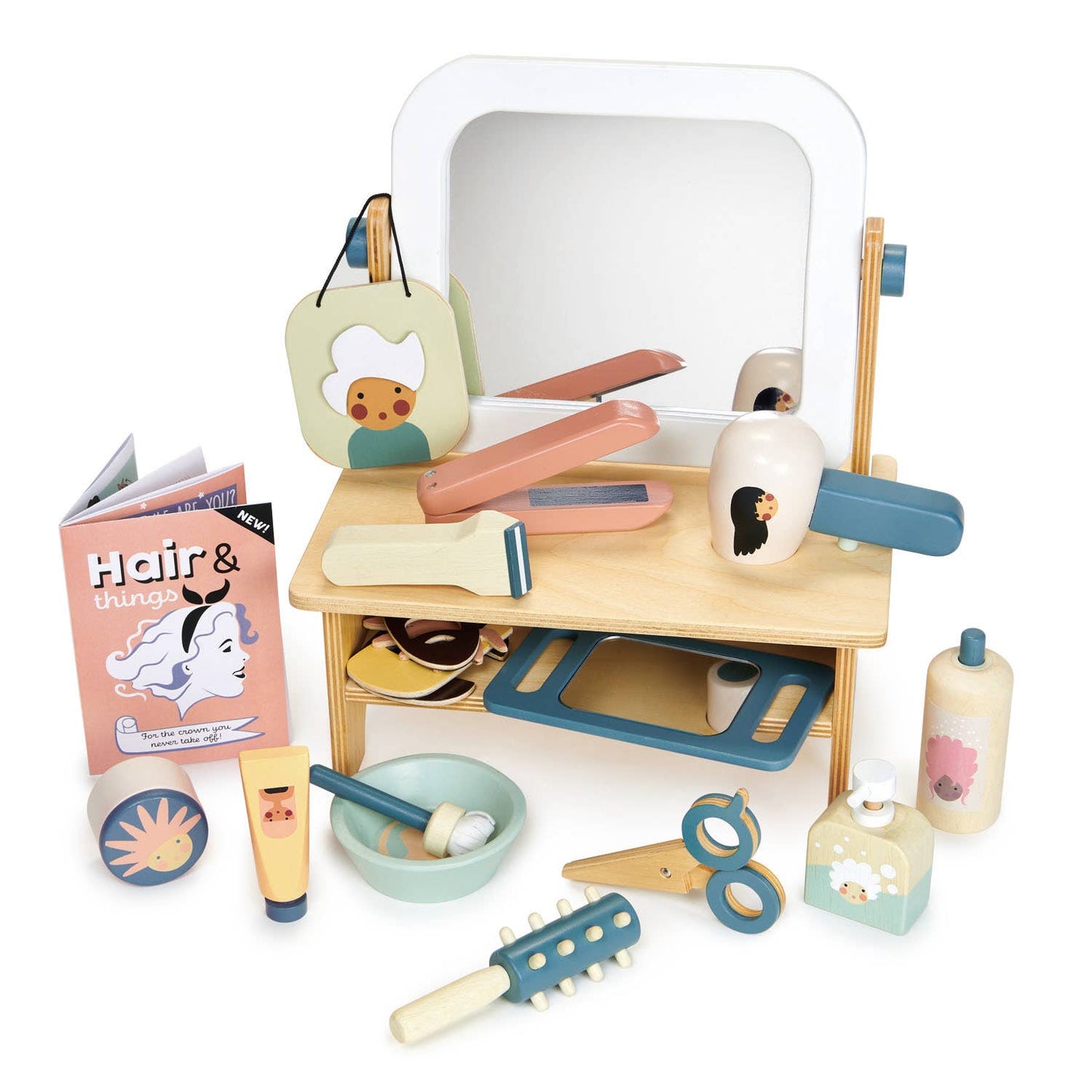Toy hair salon set with mirror, hairbrush, and other tools on a white background.