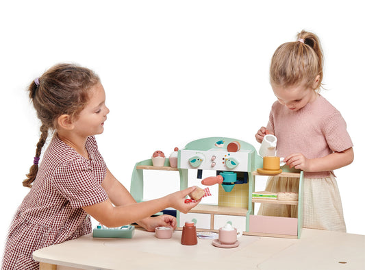 Two children playing with a wooden toy kitchen set on a white background. Great gift for toddlers.