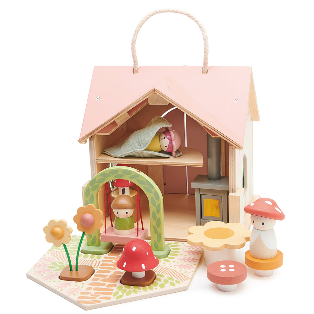 Wooden toy house with accessories on a white background. Tender Leaf Toys Rosewood cottage.
