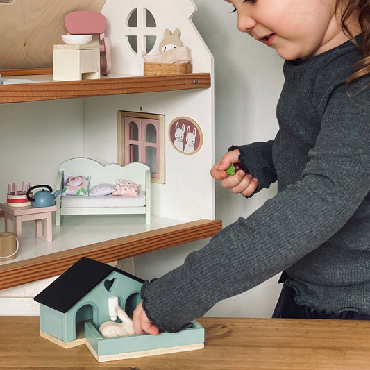 Dolls house accessories including a bunny hutch and family figures from Mucky Wolf