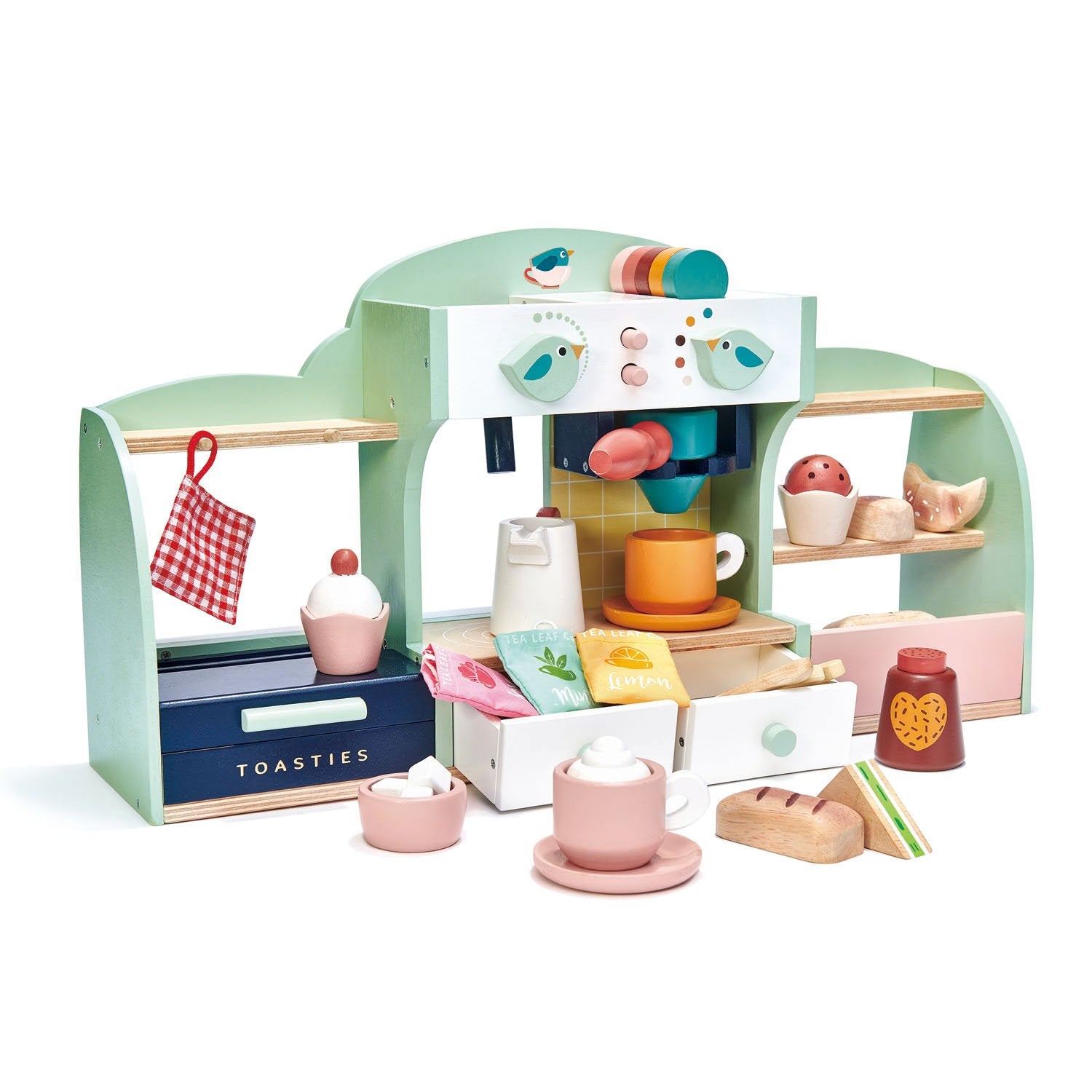 A wooden playset depicting a bird's nest-themed cafe with various toy food items and accessories, such as cups, plates, and a panini toaster, arranged on multiple levels.