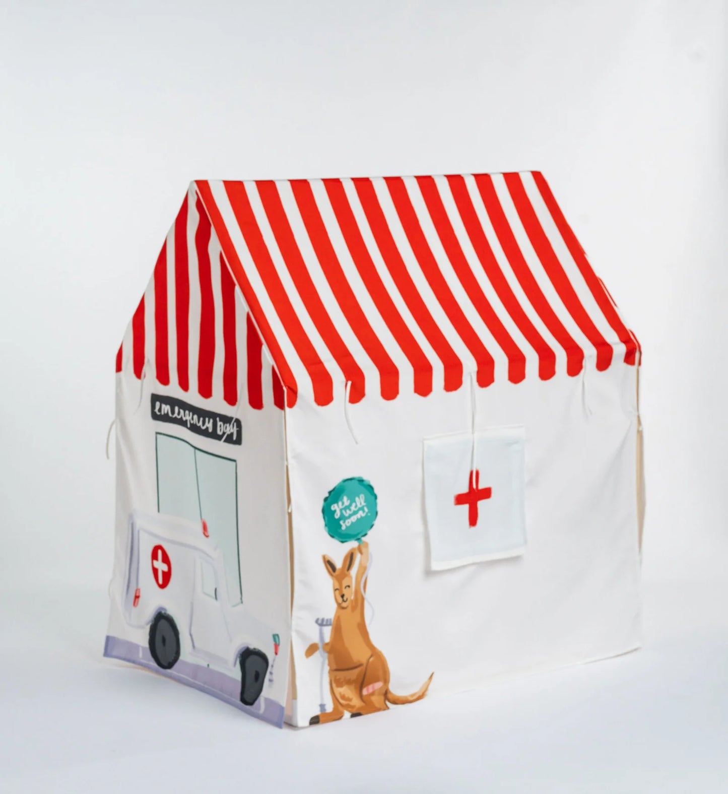 A children's fabric play tent shaped like a small ambulance station, with a red and white striped roof, a white body, printed ambulance and cross graphics, and a kangaroo illustration on a plain light background.