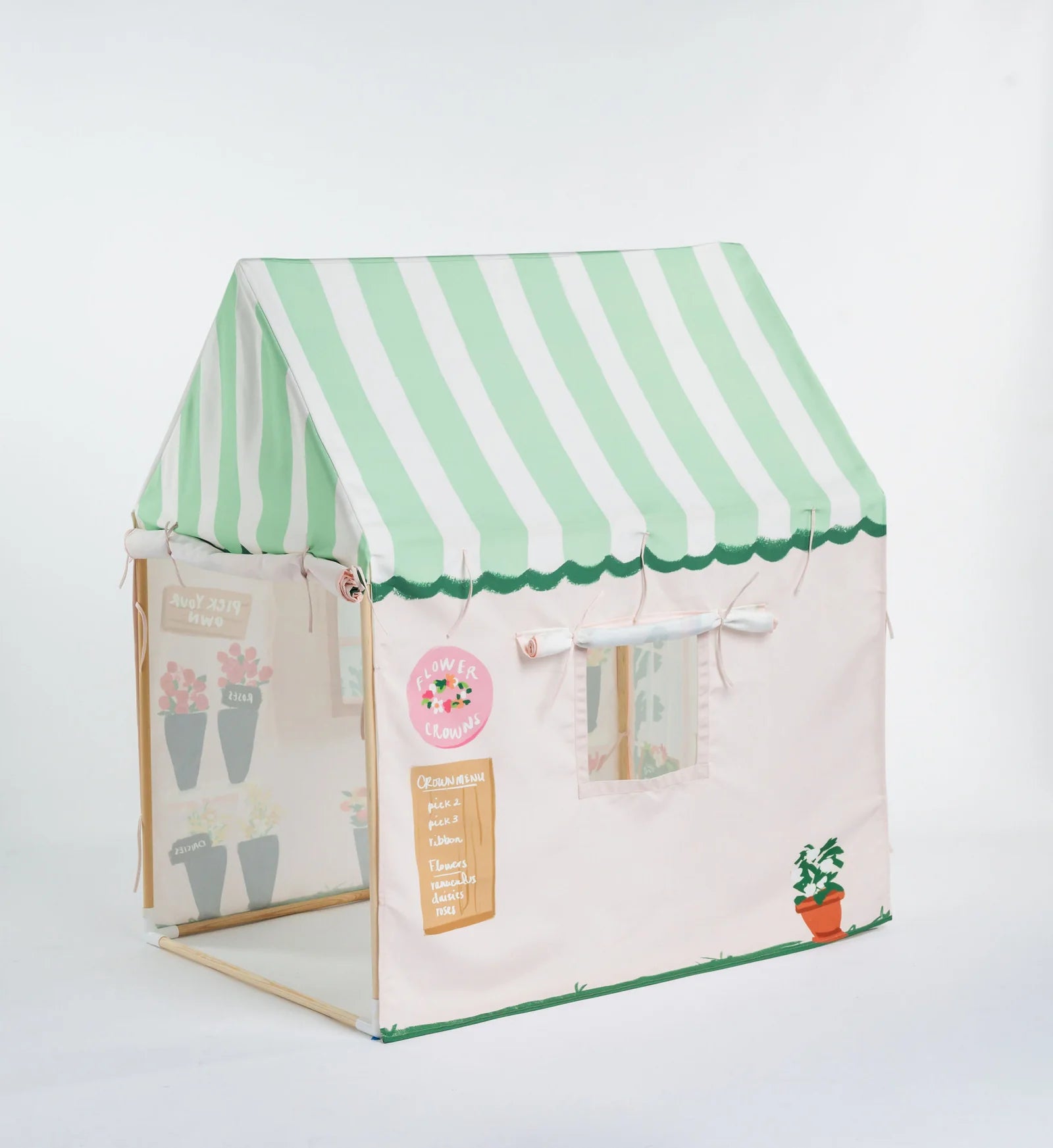 A children's fabric play tent shaped like a small house, featuring a mint green and white striped awning, a cream-colored body, and decorative garden-themed graphics including potted plants and a small sign.