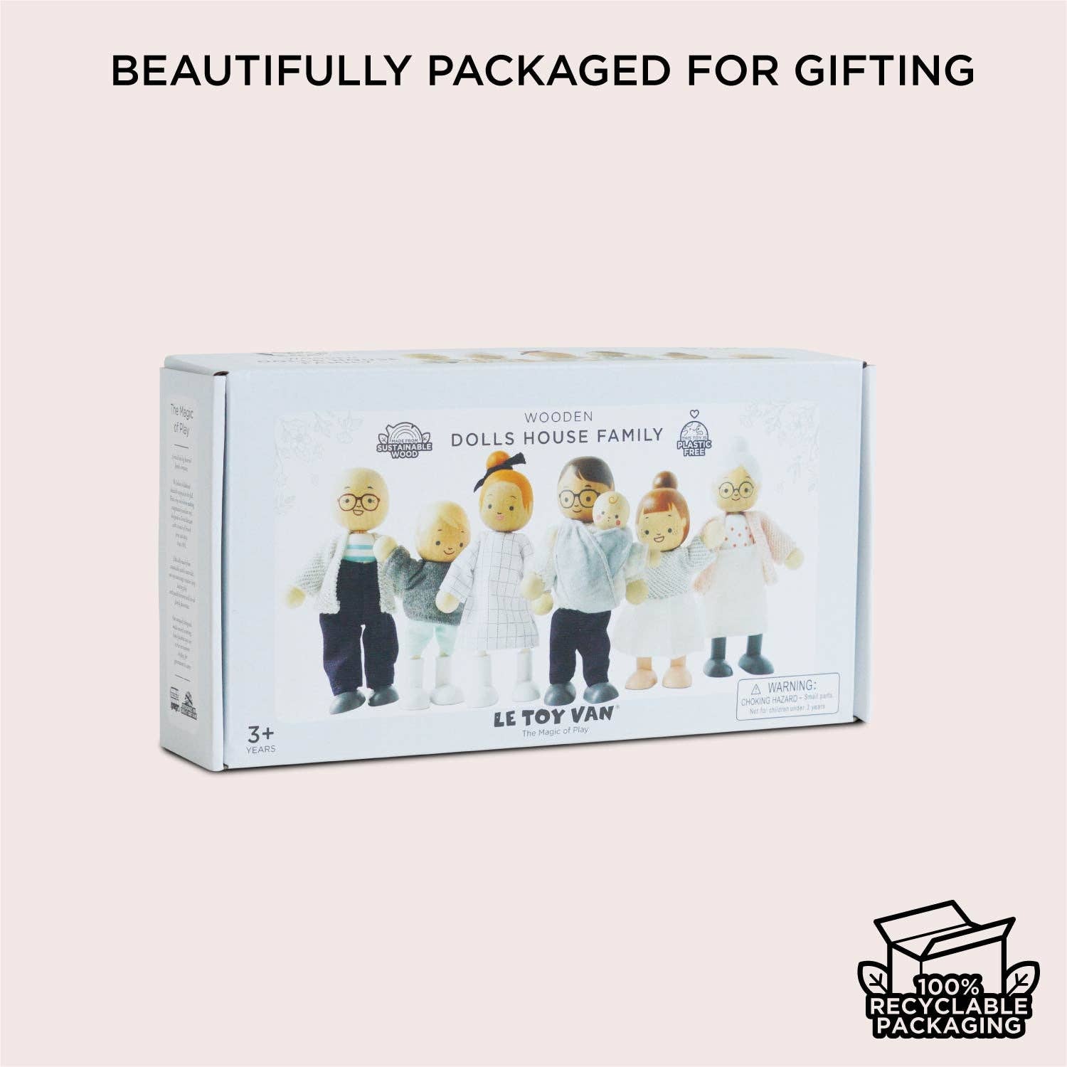 Box of Le Toy Van dolls house family set on a light pink background with text 'Beautifully packaged for gifting'.