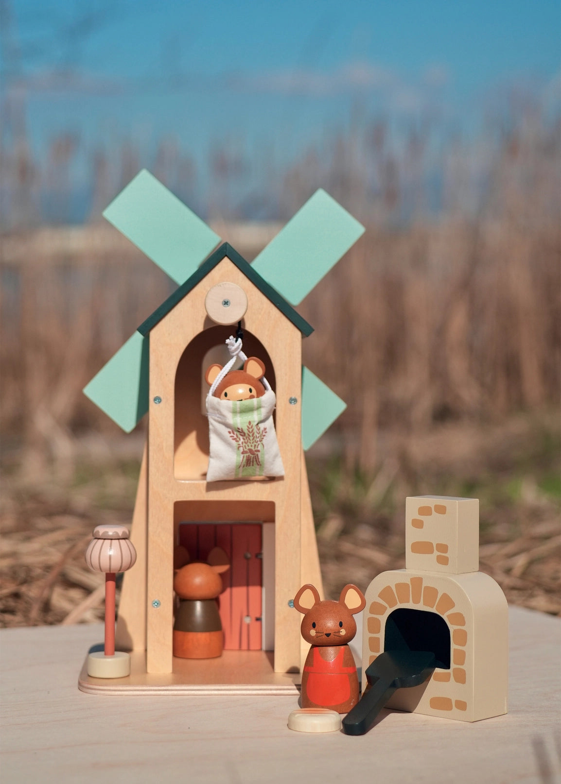 Wooden toy windmill with mouse characters against a natural background Tender Leaf Toys Penny Windmill
