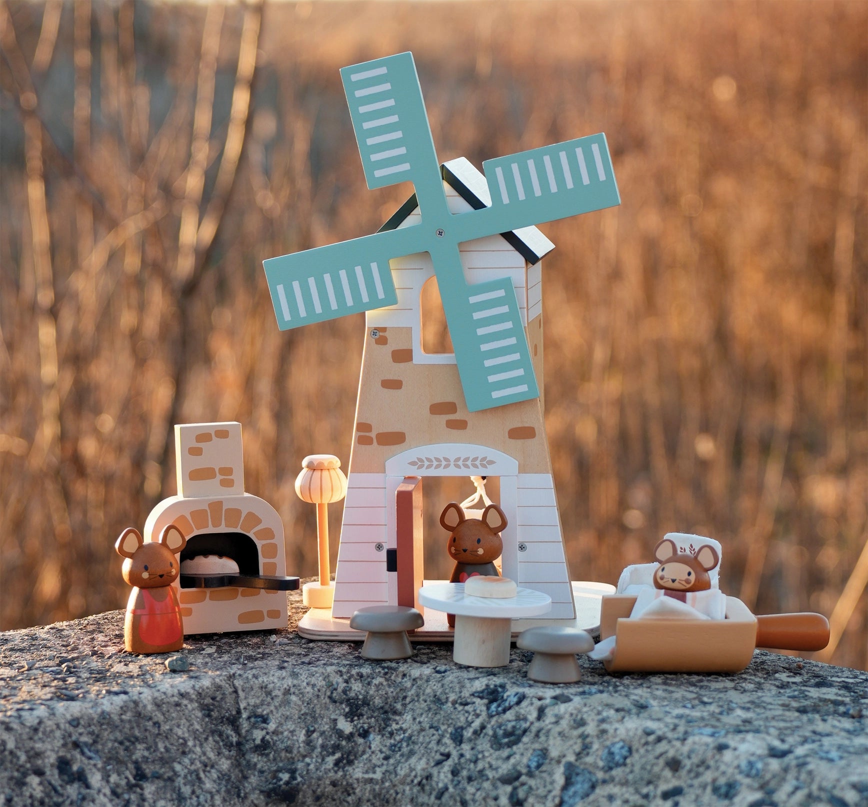 Wooden toy windmill with animals on a stone surface Tender Leaf Toys Penny Windmill