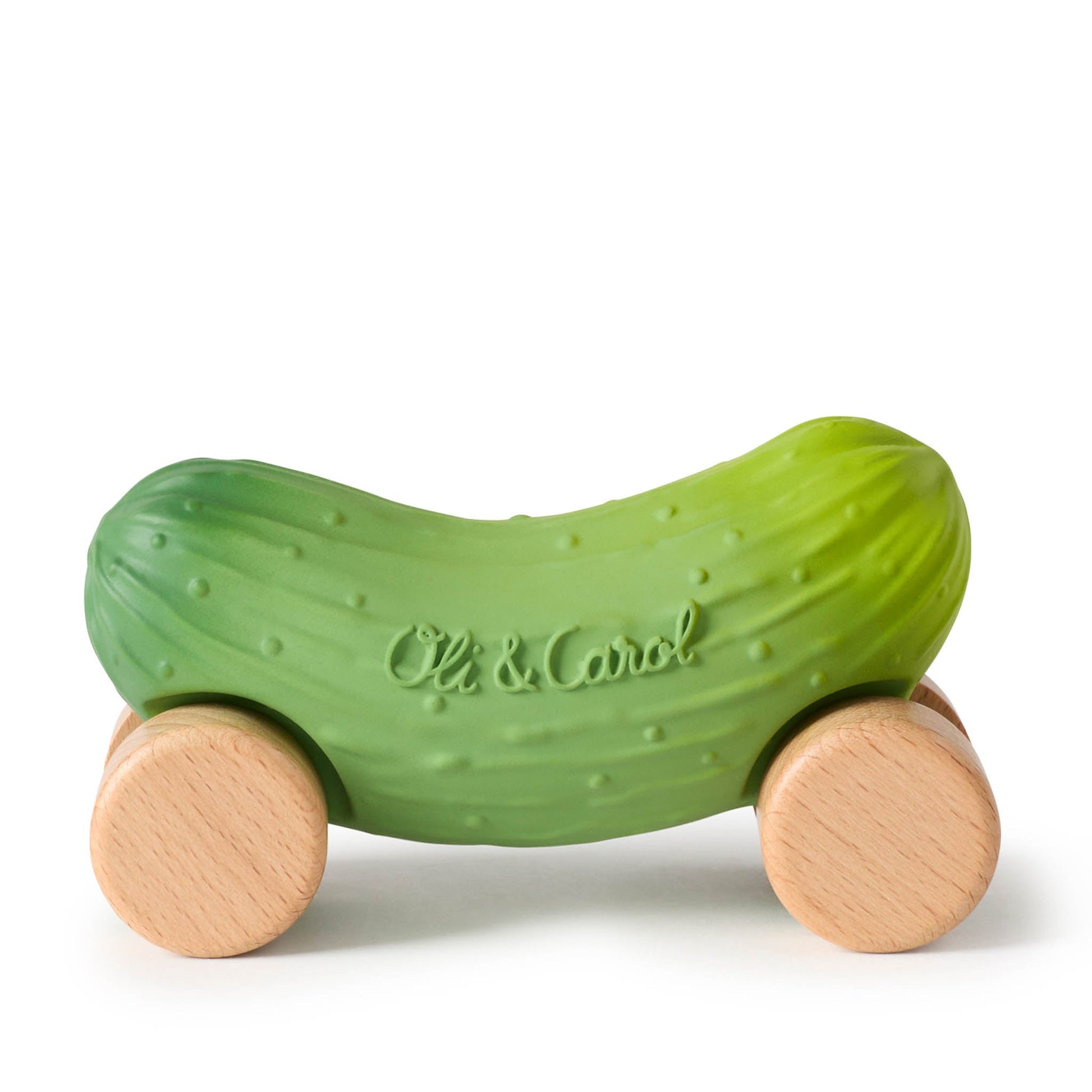 Green pickle-shaped toy with wooden wheels on a white background
