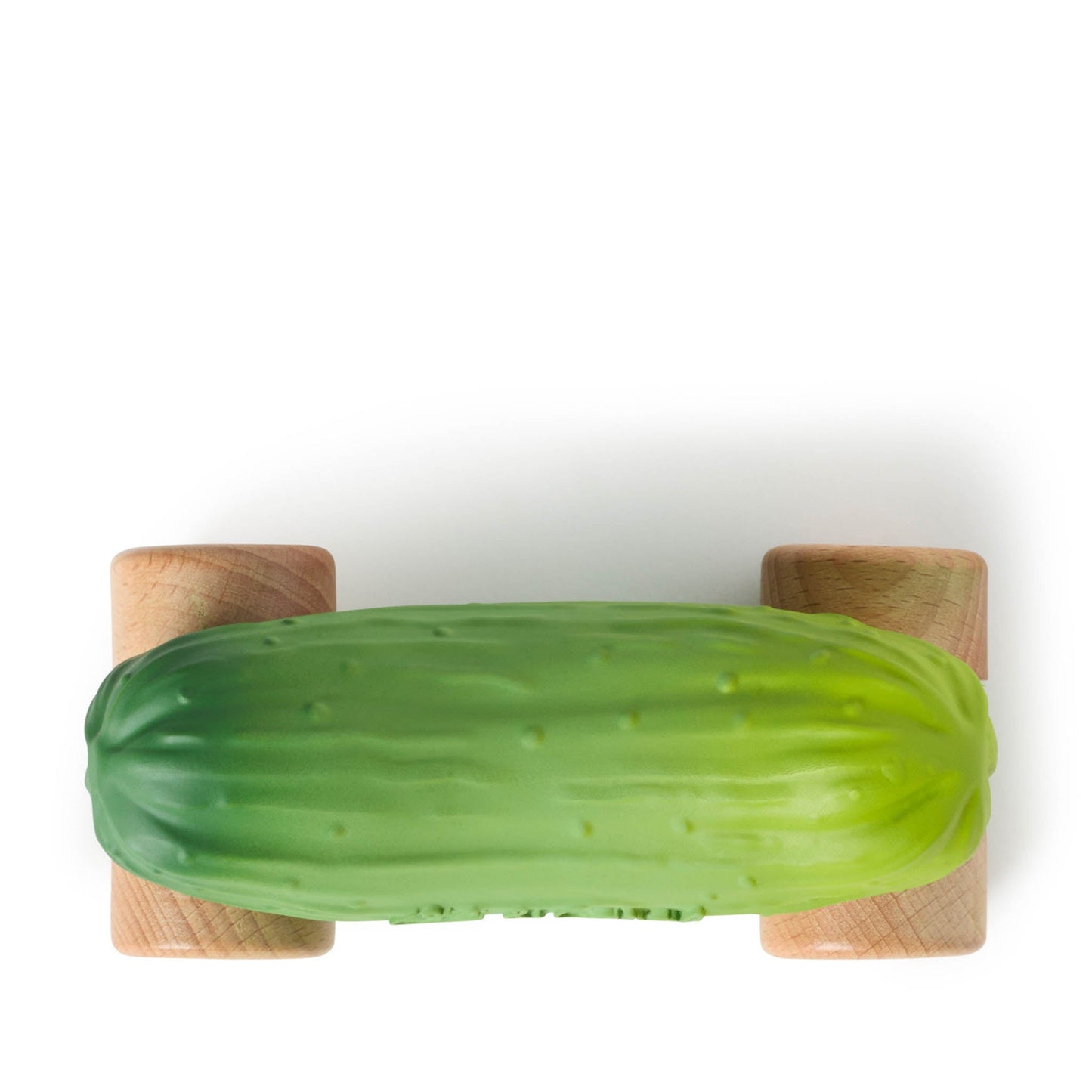 Green cucumber-shaped object on a wooden stand against a white background