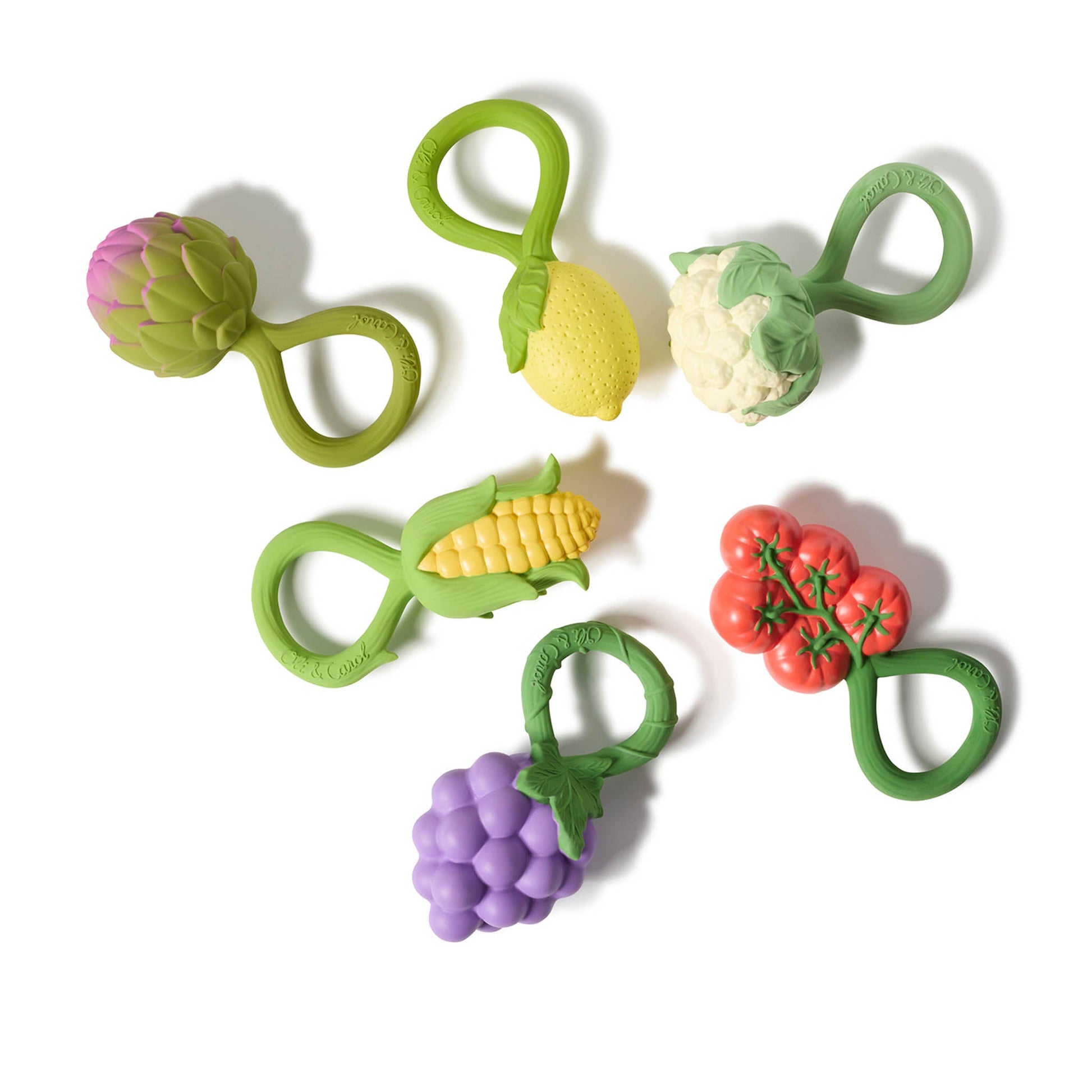 Set of colorful vegetable-shaped baby teething toys on a white background