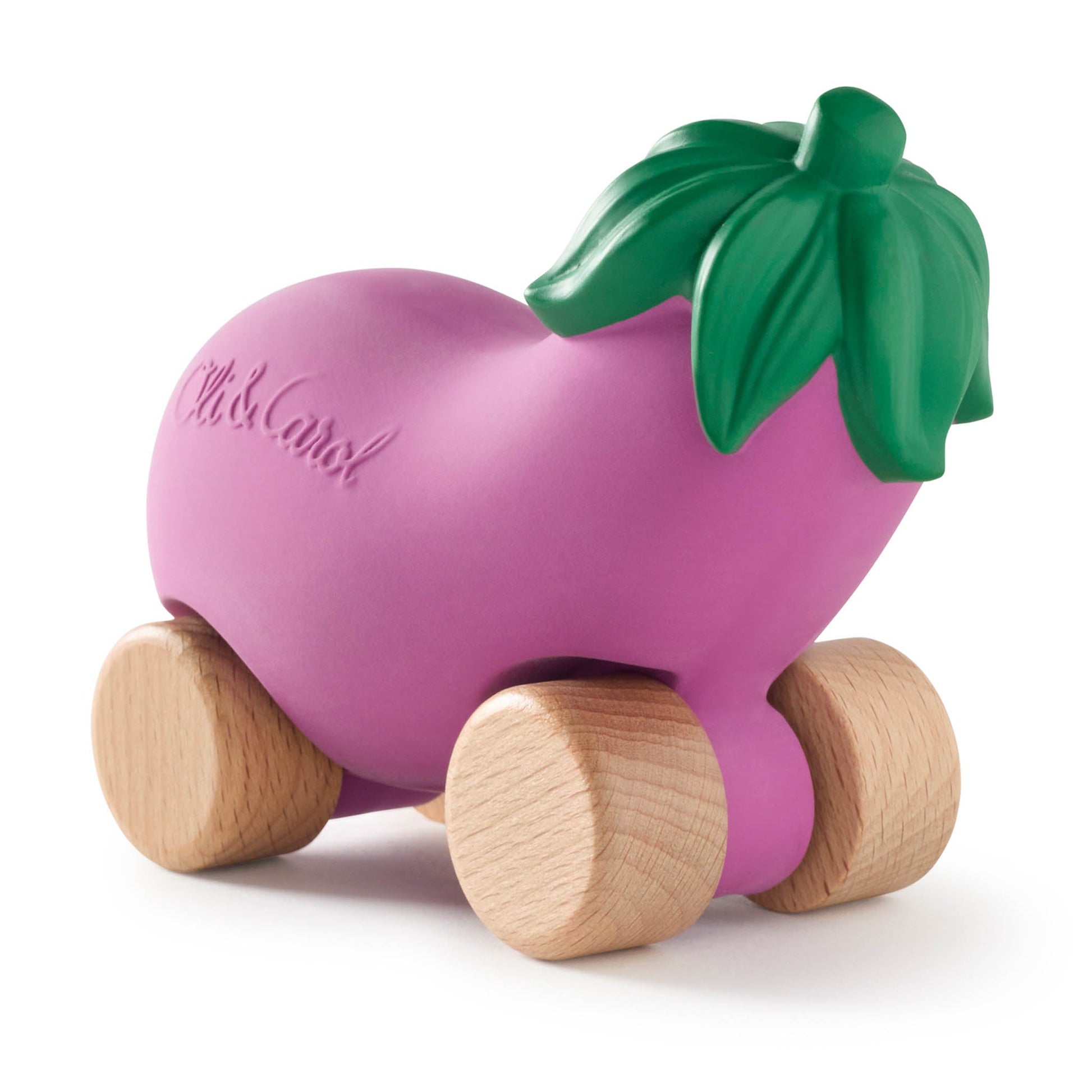 Pink toy eggplant with wooden wheels and a green leaf on a white background