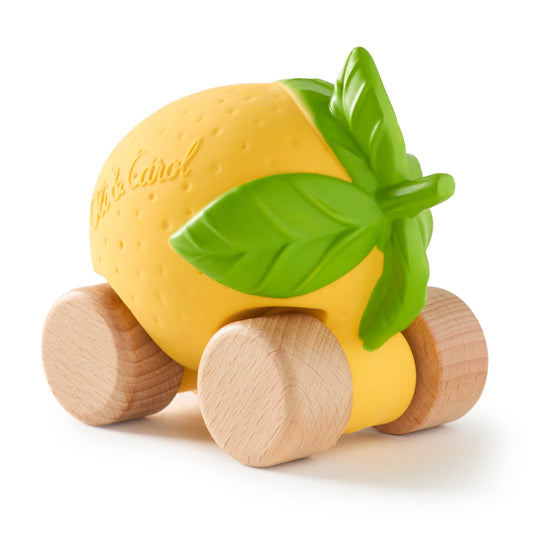 Toy lemon with wooden wheels on a white background