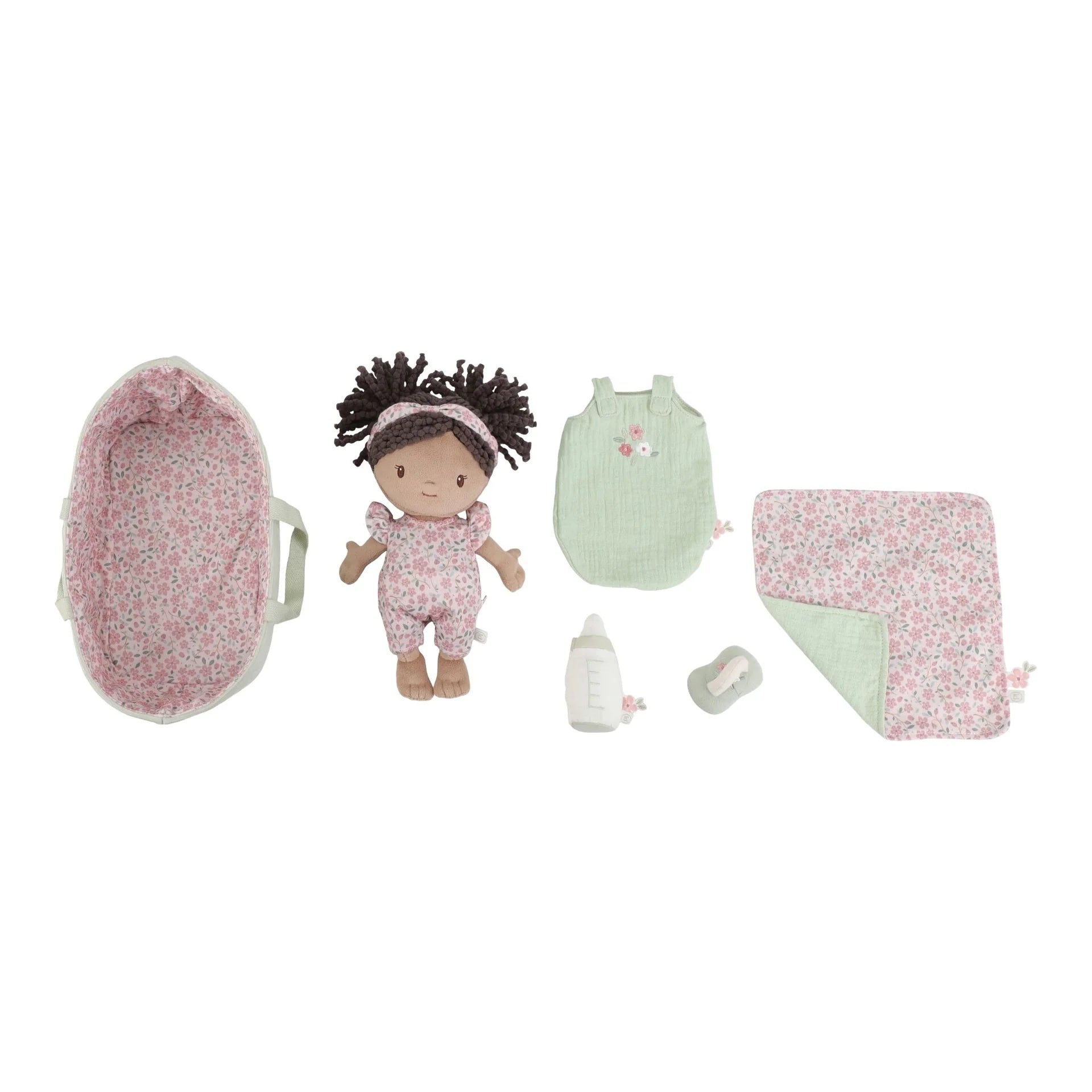 Baby doll and accessories set on a white background