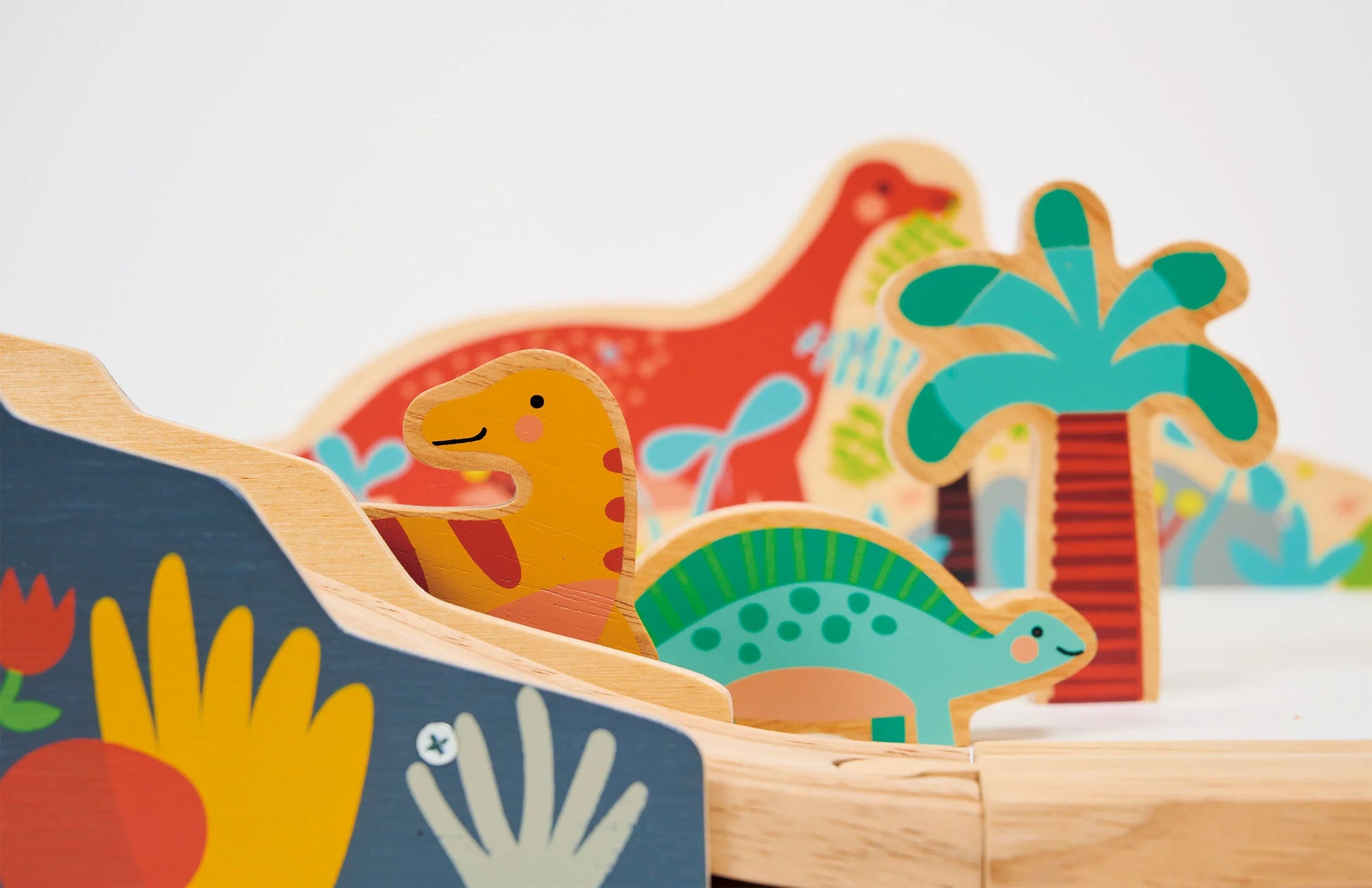 Wooden toy dinosaur on a track with colorful background. Large train track. Perfect gift.