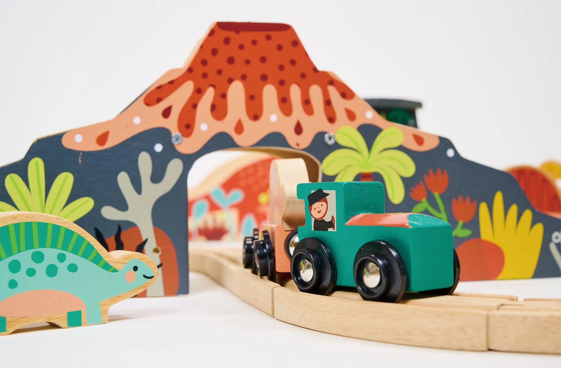 Wooden toy dinosaur on a track with colorful background. Large train track. Perfect gift.