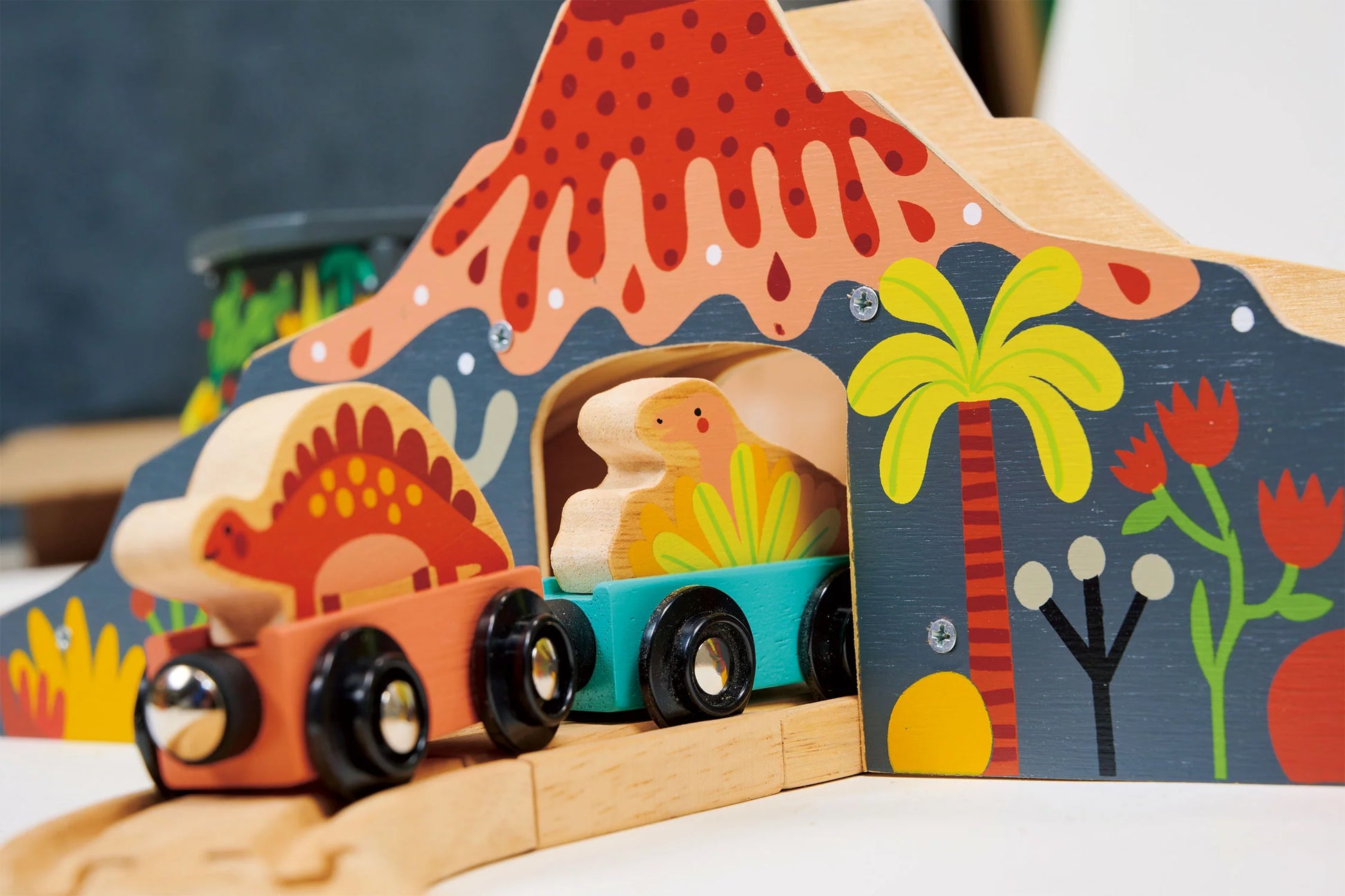 Wooden toy dinosaur on a track with colorful background. Large train track. Perfect gift.