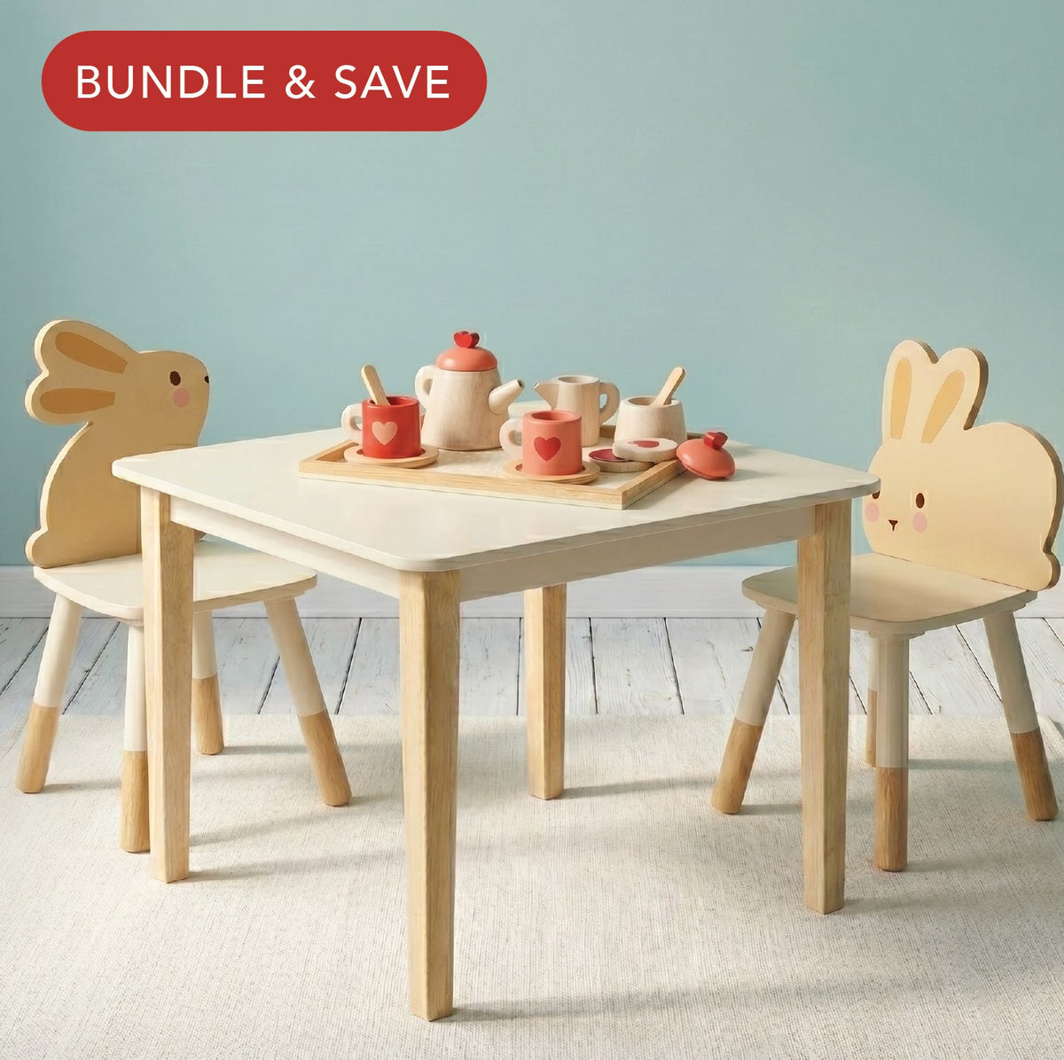Children's wooden table and chairs with bunny designs on a light blue background.