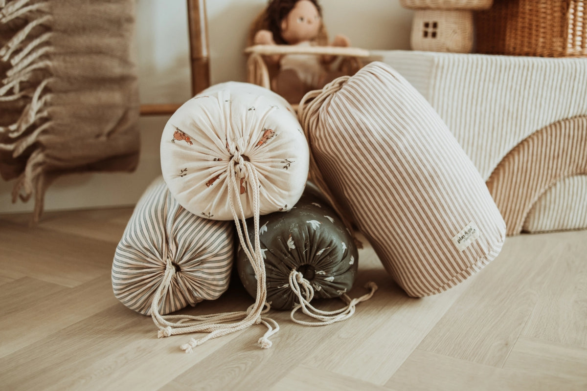 Decorative pillows on a wooden floor with a blurred background