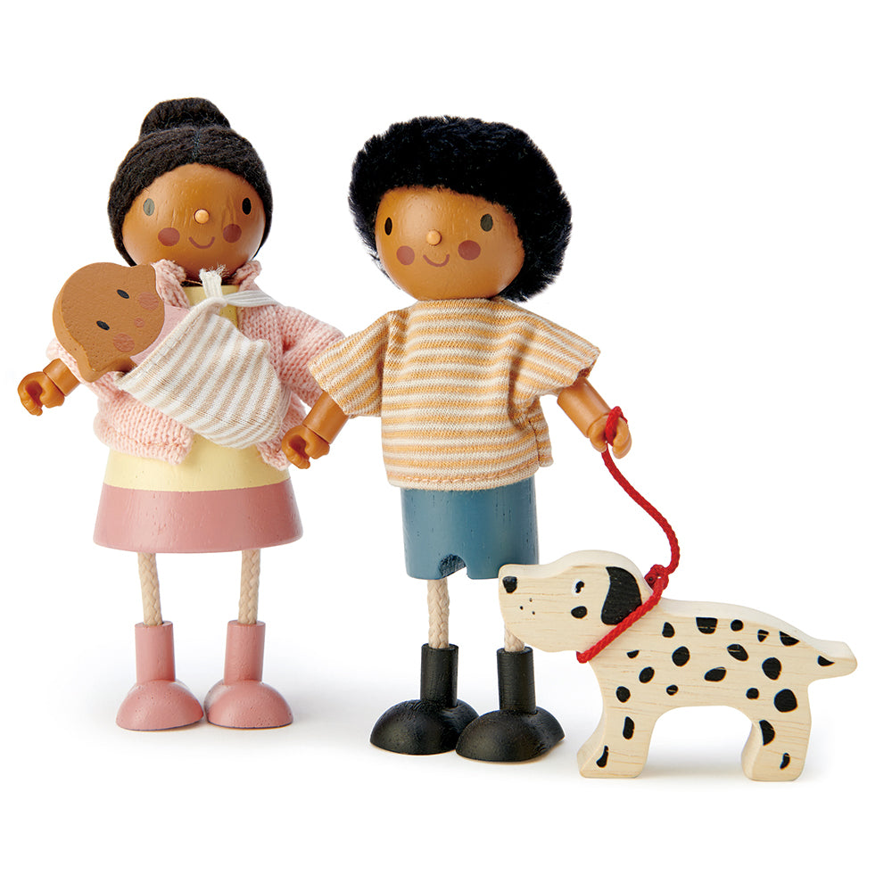 Wooden toy figures of a family with a child holding a dog on a white background