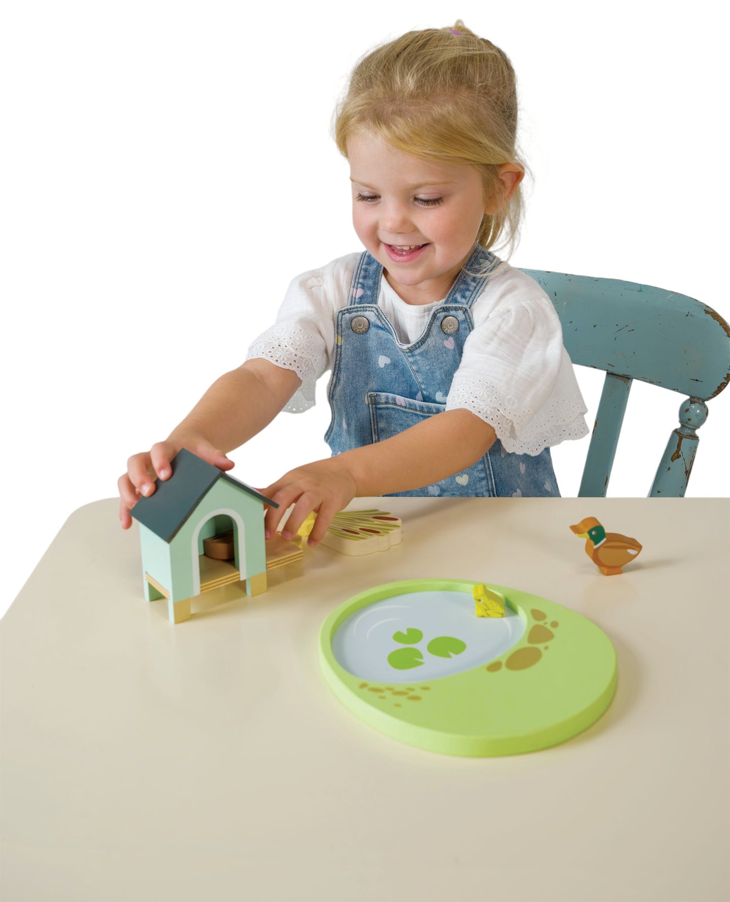 Child playing with wooden toys at a table