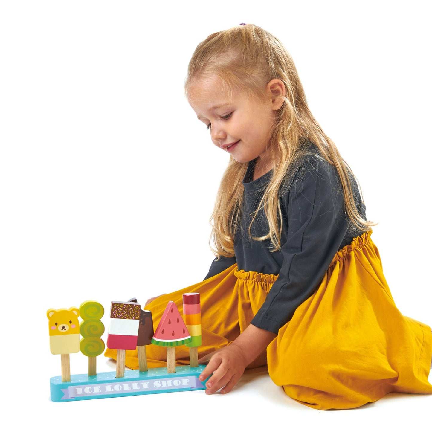 Child playing with a colorful toy on a white background