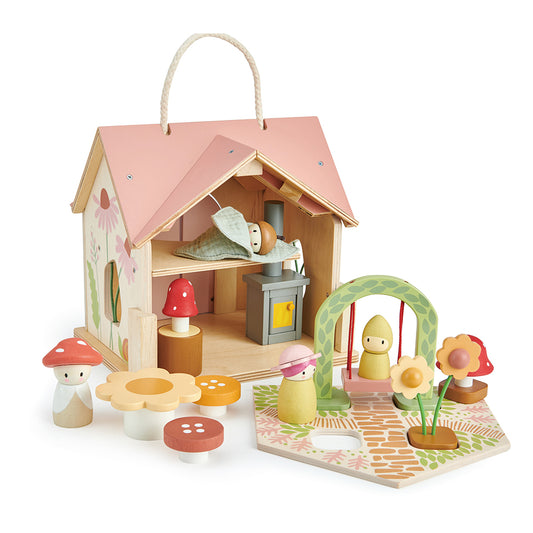 Wooden toy house with various accessories on a white background. Tender Leaf Toys Rosewood cottage.